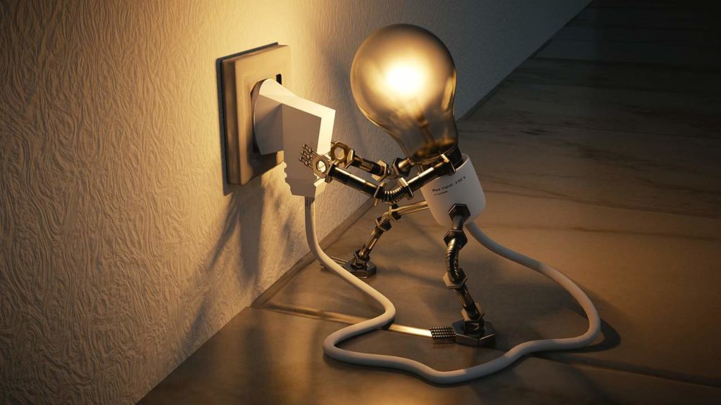 creative image of a lightbulb plugging in its own power source into the wall