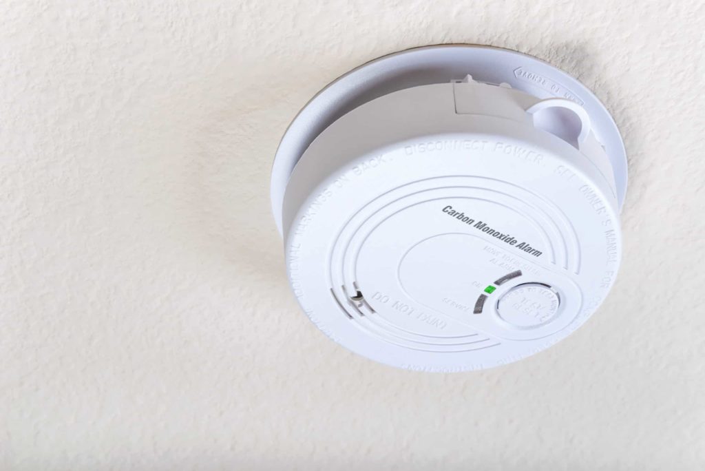 closeup of carbon monoxide detector armed on the ceiling