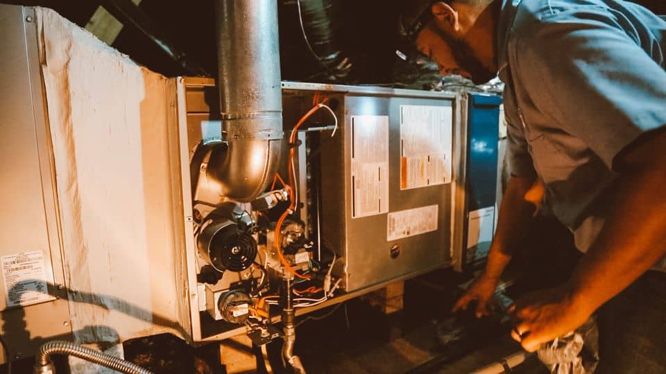 technician inspecting an hvac unit in austin home