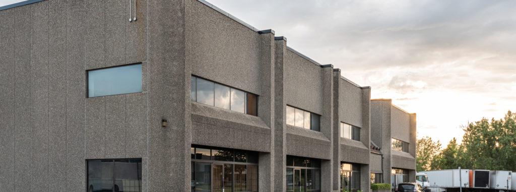 commercial building with sunset setting behind it