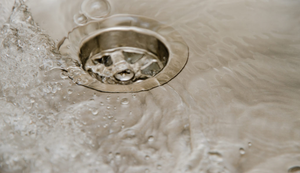 water draining into kitchen sink drain