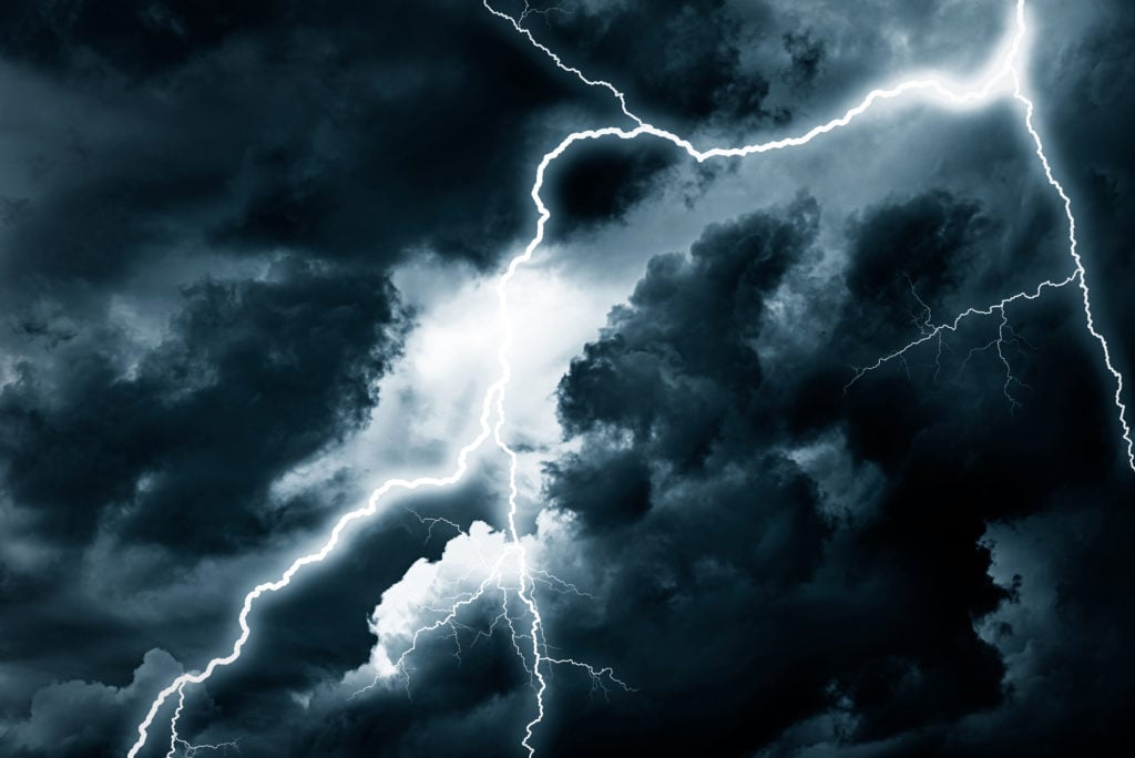 Lightning strike against the background of a cloudy dark sky.