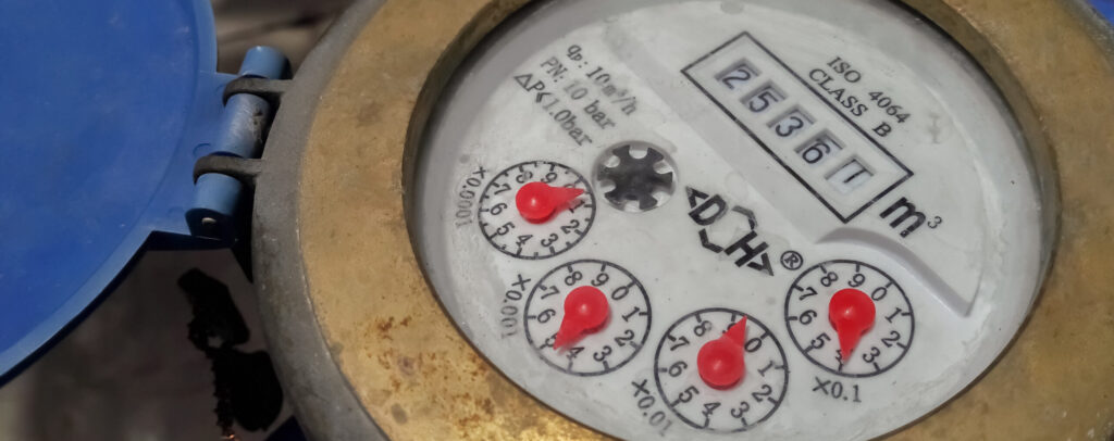 water meter attached to a Austin home with a leak