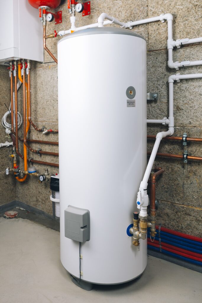 tanked water heater system installed inside of a boiler room