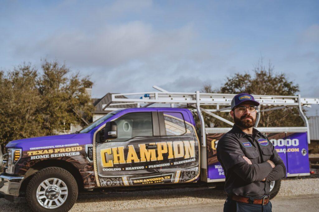 champion technician standing in front of truck